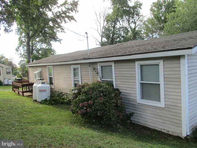 a front view of house with yard and outdoor seating