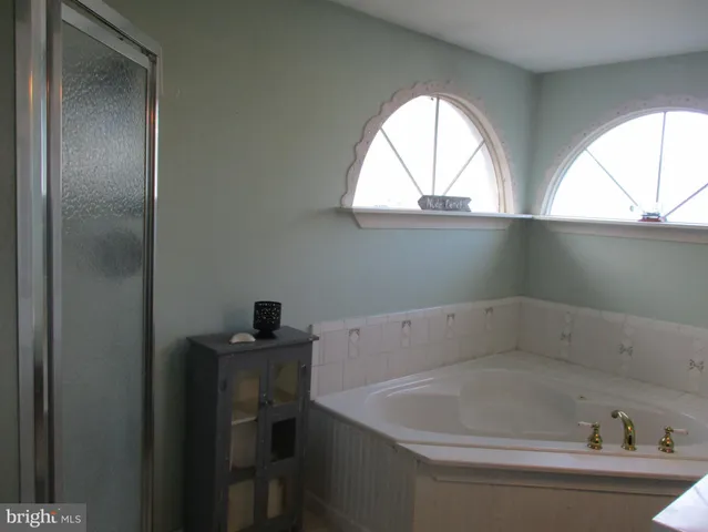 a bathroom with a bathtub and a window