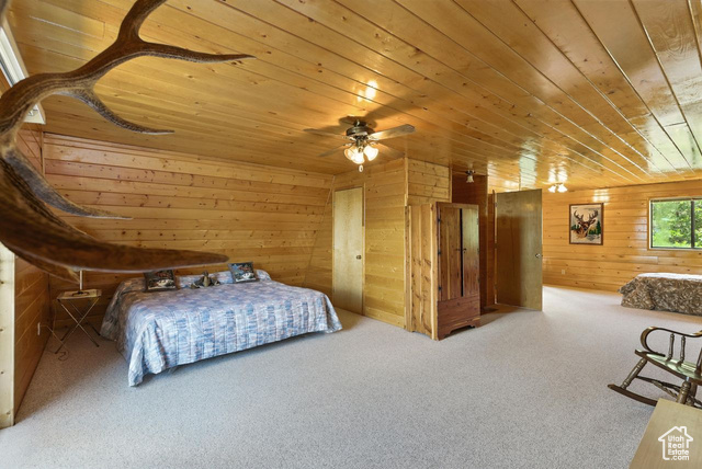 1180 Oak Road Coalville, UT 84017 - Photo 12 of 25 Carpeted bedroom with wooden walls and wooden ceiling