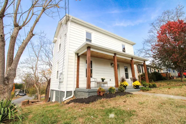 a view of a house with a yard covered in snow