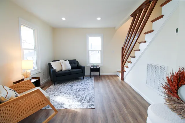 a view of a sink a faucet a chandelier and living room view
