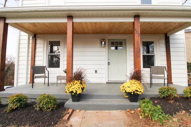 a front view of a house with outdoor seating