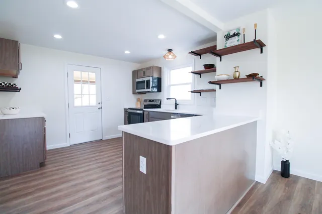 a kitchen with cabinets a sink and appliances