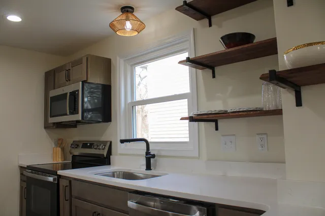 a view of staircase with white walls and a window