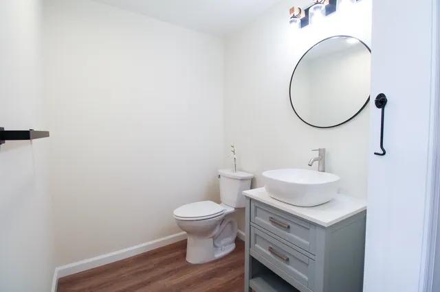 a view of a hallway with wooden floor and closet area