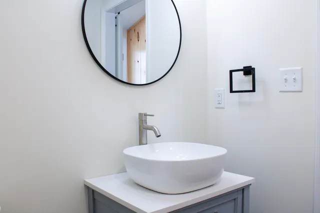 a bathroom with a toilet sink and mirror