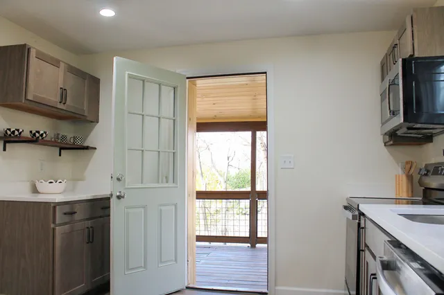 a view of a room with wooden floor and a window
