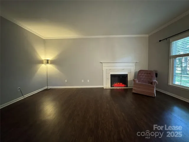 a living room with hard wood floors and a fireplace