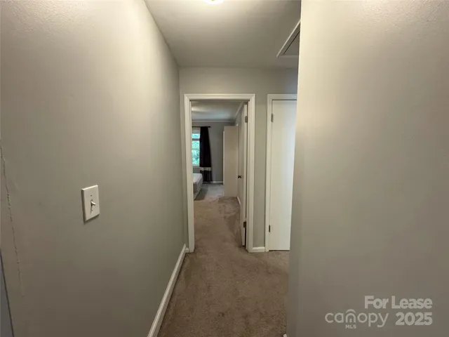 a spacious bedroom with a bed and a chandelier