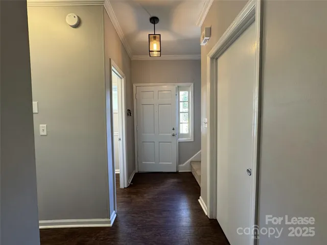 a view of a hallway with wooden floor