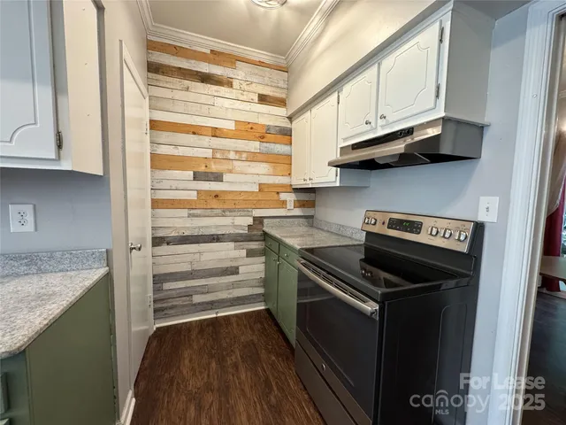 a kitchen with stainless steel appliances granite countertop a stove and a refrigerator