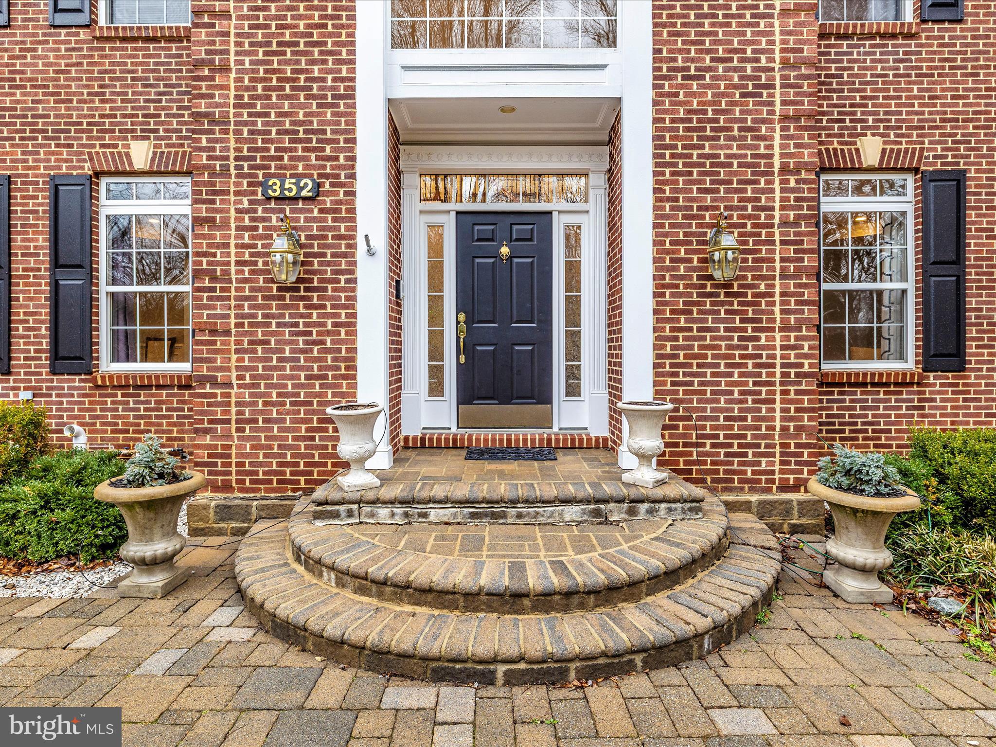 352 Ridge Road Washington Grove, MD 20880 - Photo 2 of 58 a view of a brick house with table and chairs
