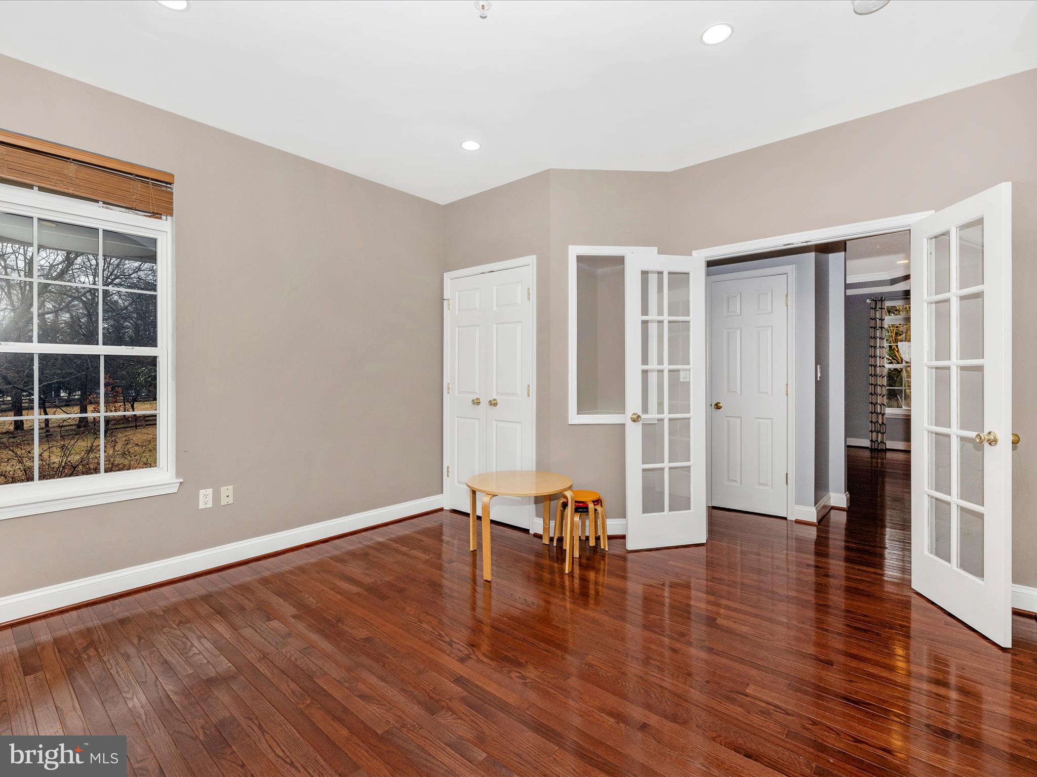 352 Ridge Road Washington Grove, MD 20880 - Photo 22 of 58 an empty room with wooden floor and windows