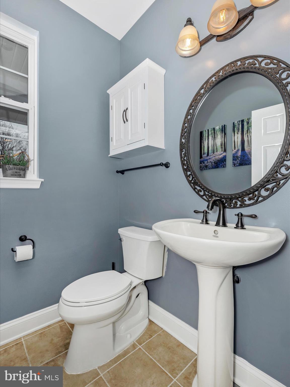 352 Ridge Road Washington Grove, MD 20880 - Photo 23 of 58 a bathroom with a toilet a sink and a mirror
