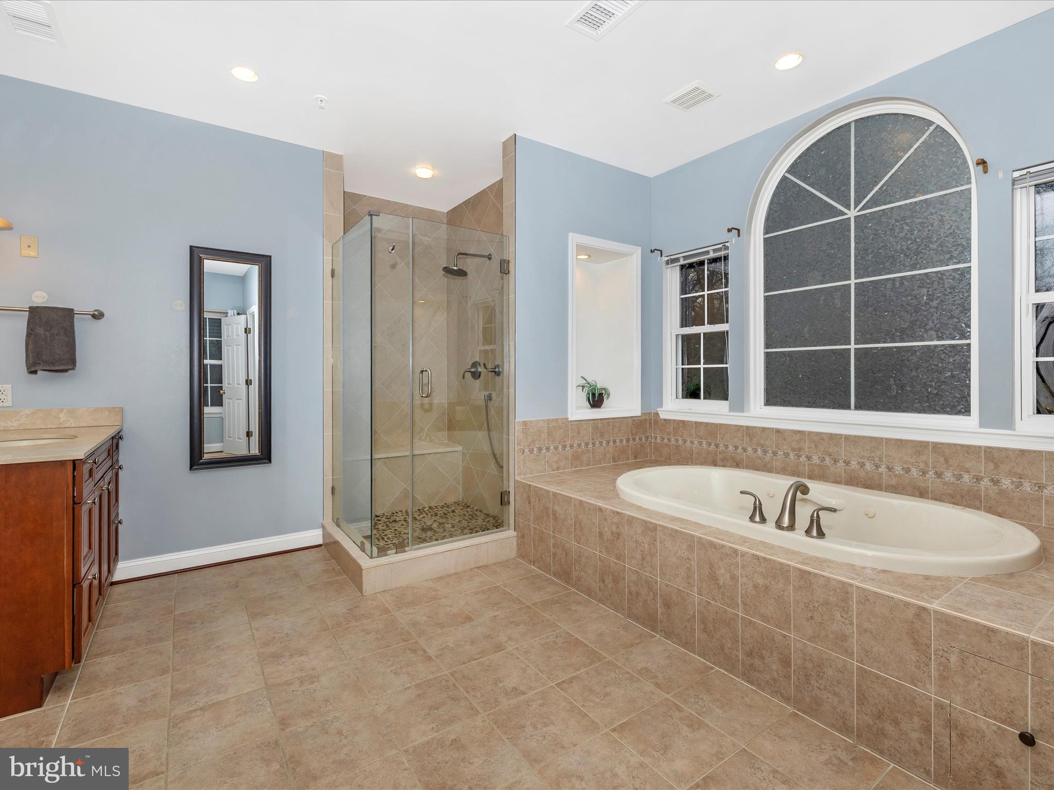 352 Ridge Road Washington Grove, MD 20880 - Photo 27 of 58 a spacious bathroom with a tub a sink and a shower