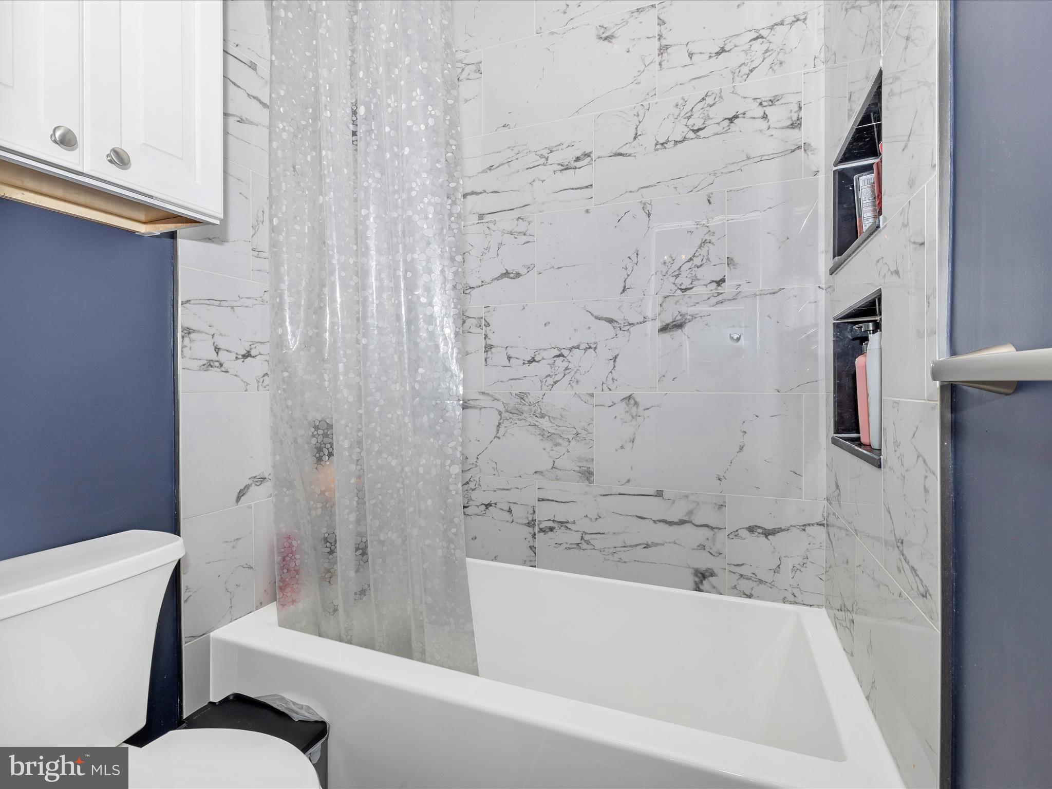 352 Ridge Road Washington Grove, MD 20880 - Photo 35 of 58 a bathroom with a bathtub and toilet