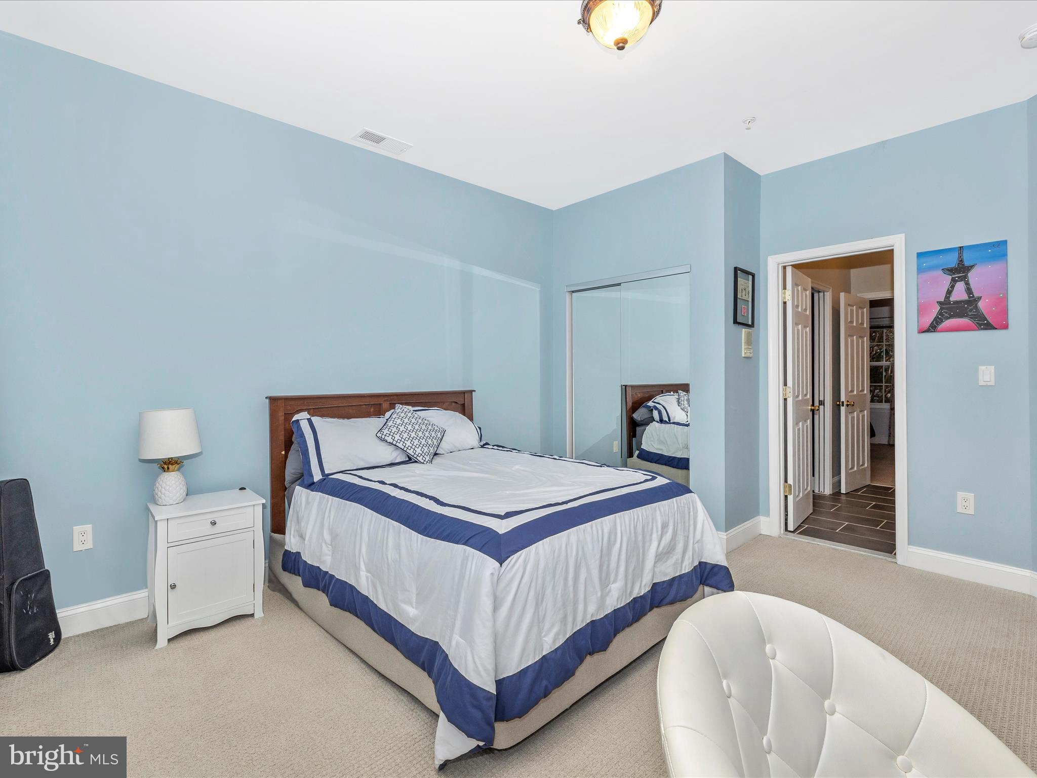 352 Ridge Road Washington Grove, MD 20880 - Photo 37 of 58 a bedroom with a bed and a lamp