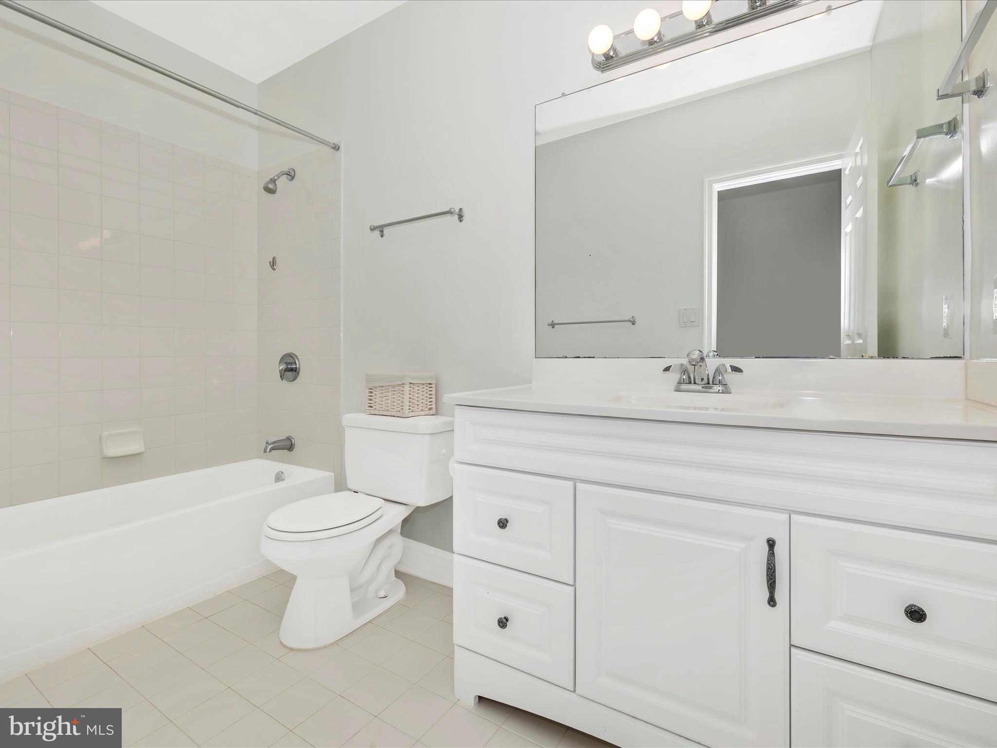 352 Ridge Road Washington Grove, MD 20880 - Photo 43 of 58 a bathroom with a toilet a sink a mirror a bathtub and vanity