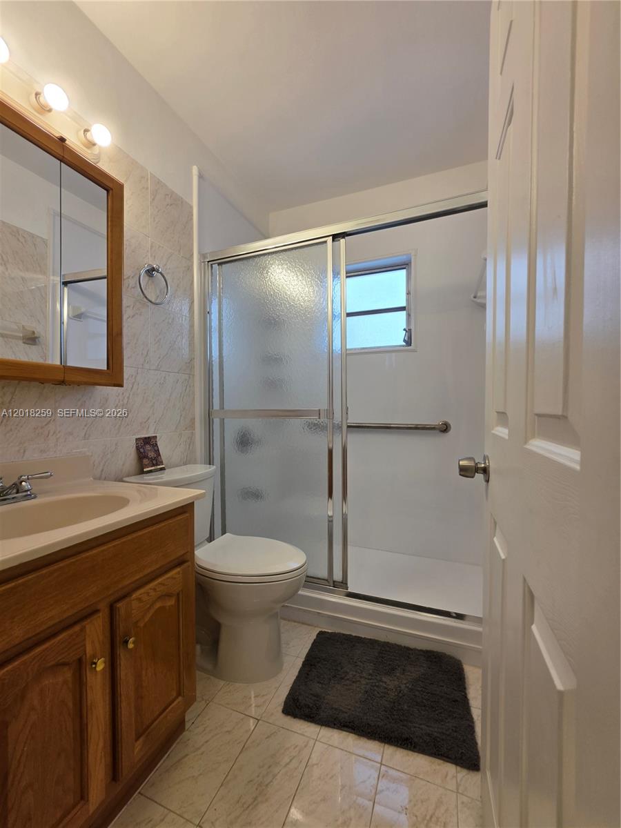4601 Southwest 5th Street Miami, FL 33134 - Photo 16 of 23 a bathroom with a sink a toilet and shower