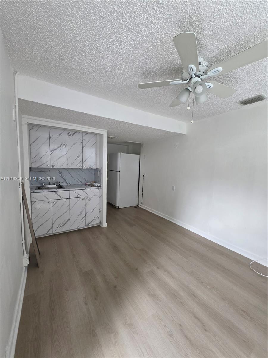 4601 Southwest 5th Street Miami, FL 33134 - Photo 20 of 23 a view of room with hardwood floor and ceiling fan