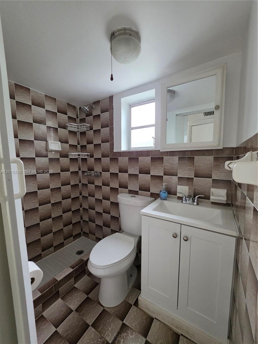 4601 Southwest 5th Street Miami, FL 33134 - Photo 22 of 23 a bathroom with a toilet a sink and mirror