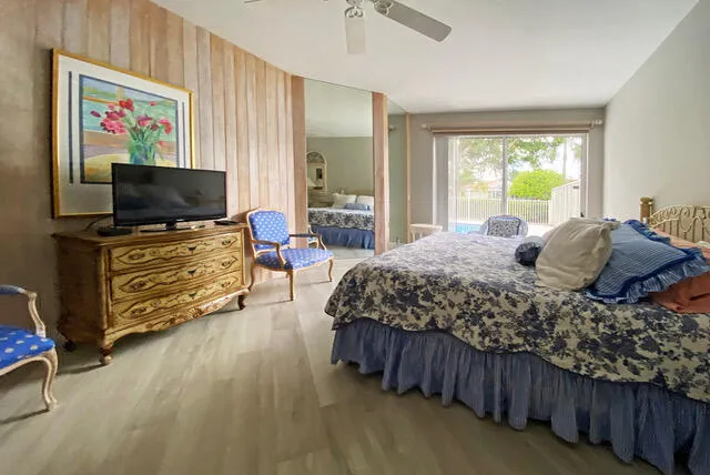 a bedroom with a bed and a flat screen tv