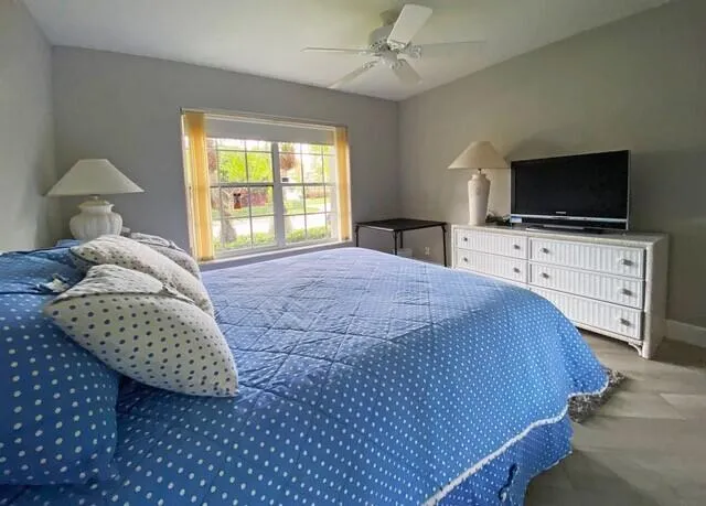 a bedroom with a bed and a flat screen tv