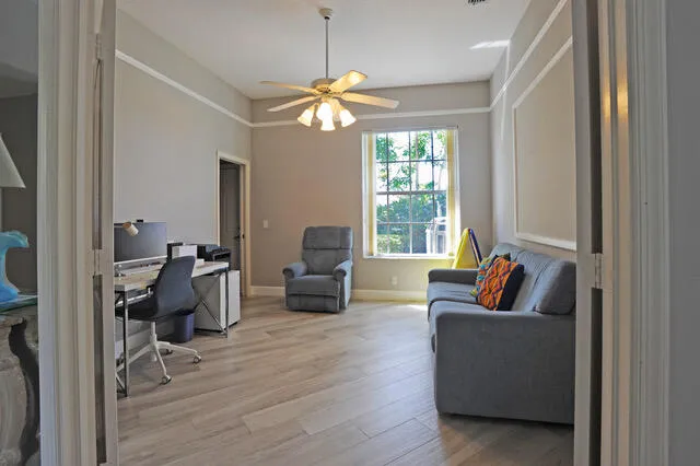 a living room with furniture and a large window