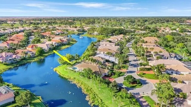 an aerial view of residential houses with outdoor space and river