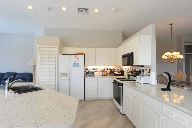 a kitchen with refrigerator and stove