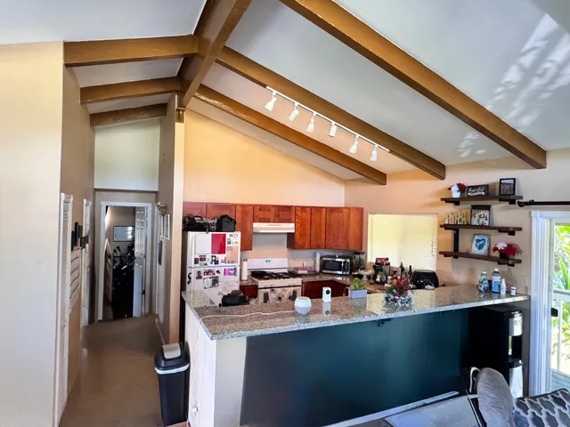 a kitchen with stainless steel appliances a sink stove and refrigerator