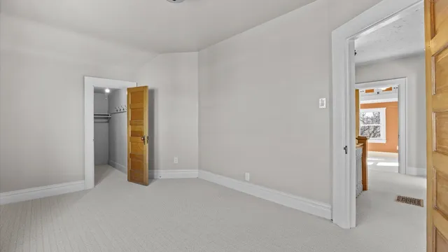 a bedroom with a bed and flat screen tv