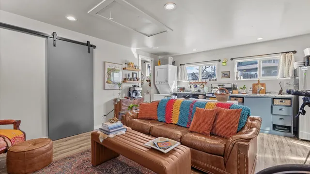a living room with furniture kitchen and a window