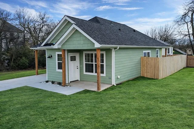 a front view of a house with a yard and porch