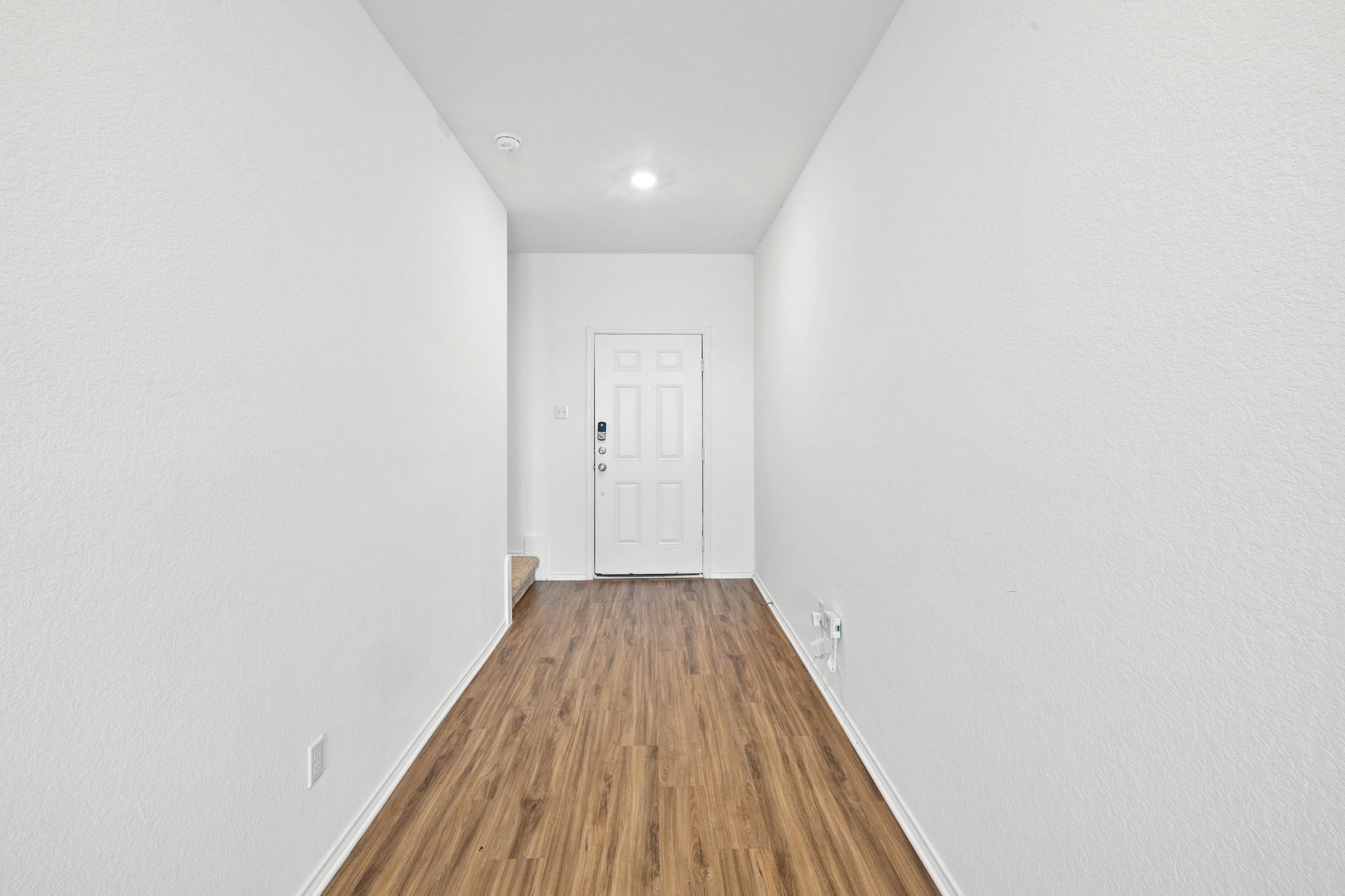 141 Mica Trail Maxwell, TX 78656 - Photo 2 of 30 a view of a hallway with wooden floor
