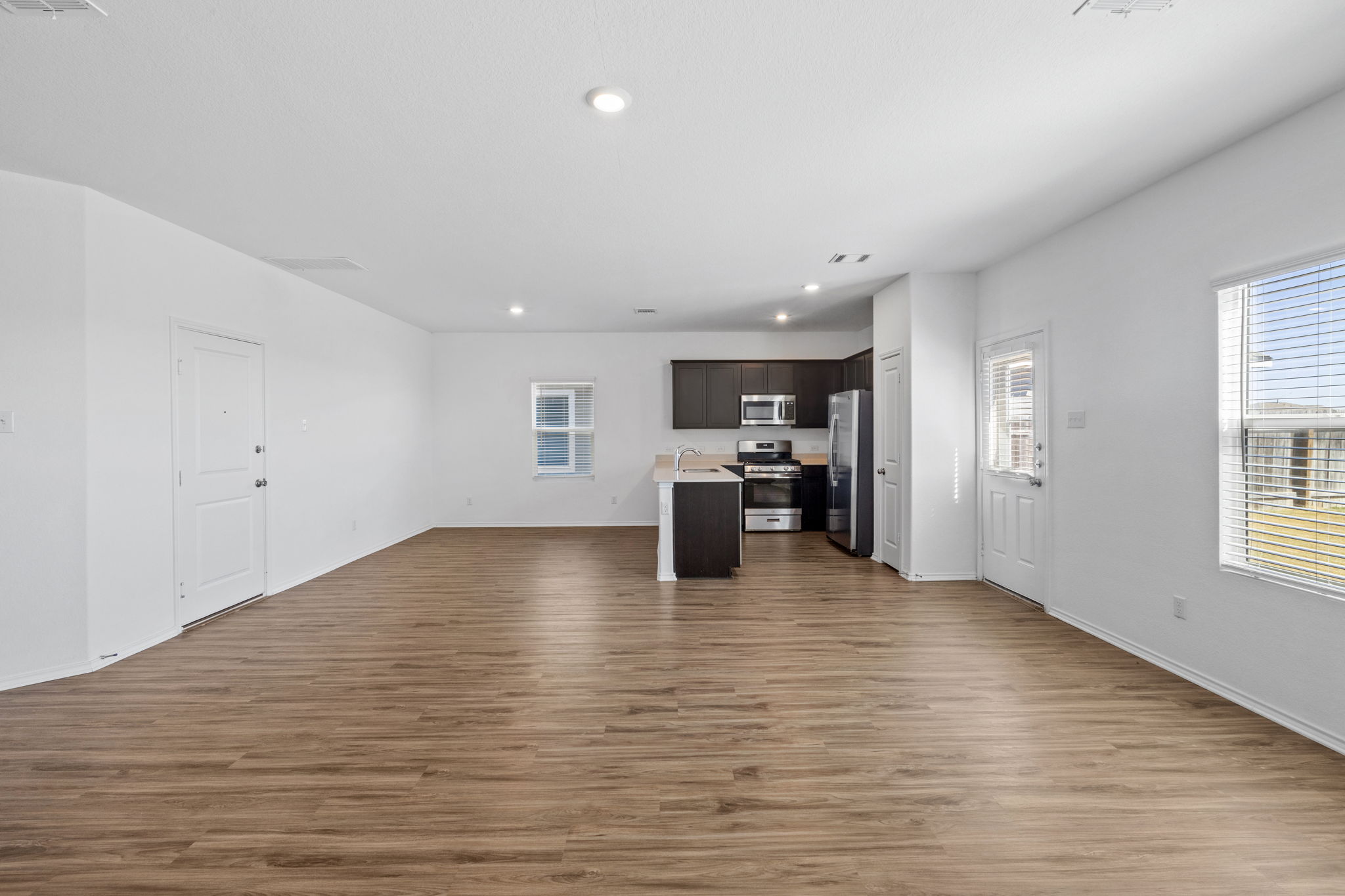 141 Mica Trail Maxwell, TX 78656 - Photo 7 of 30 a view of kitchen and hall with wooden floor