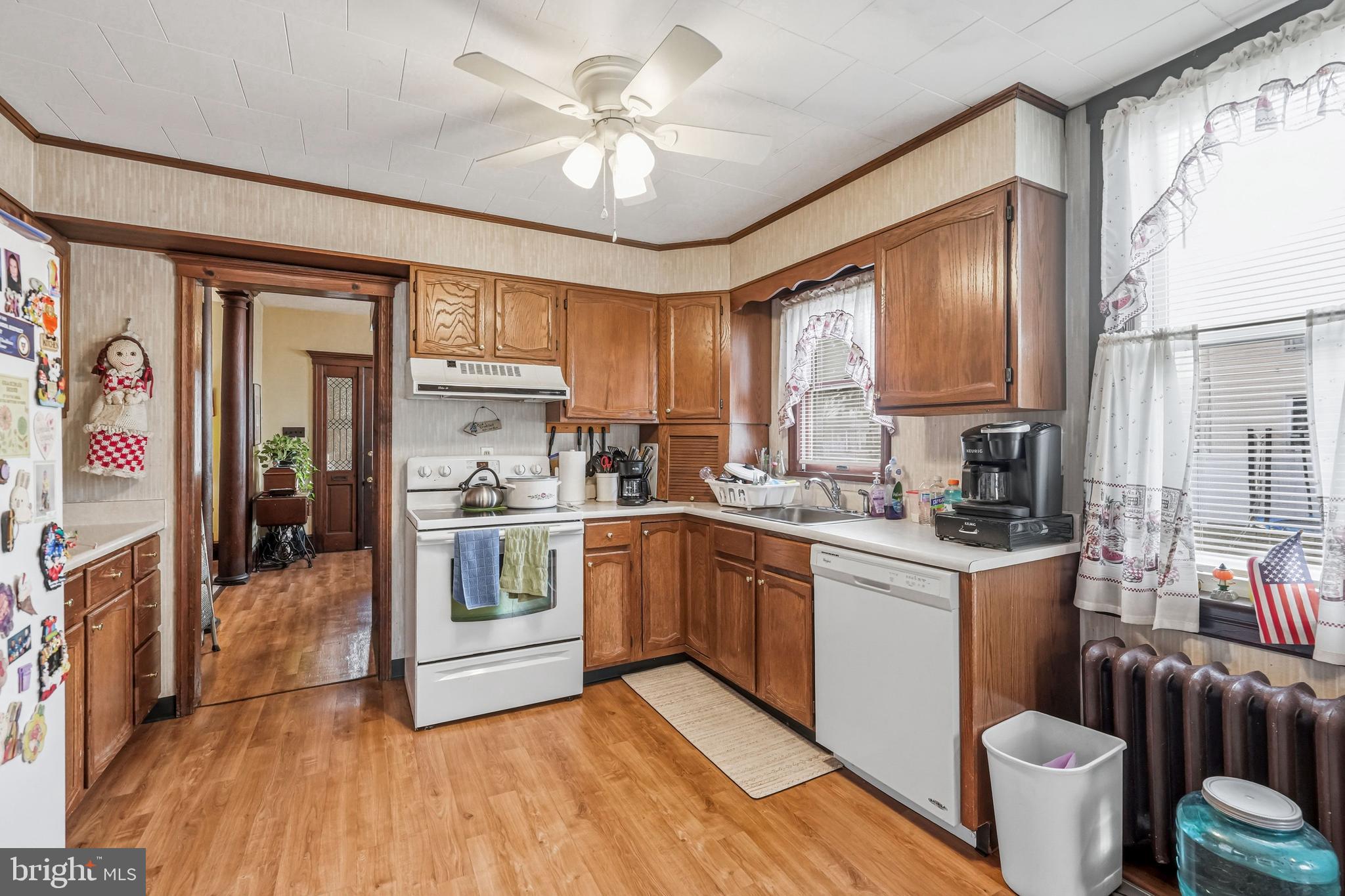 300 Delaware Avenue Riverside, NJ 08075 - Photo 19 of 86 a kitchen with stainless steel appliances granite countertop a stove top oven a sink dishwasher a refrigerator with white cabinets and wooden floor