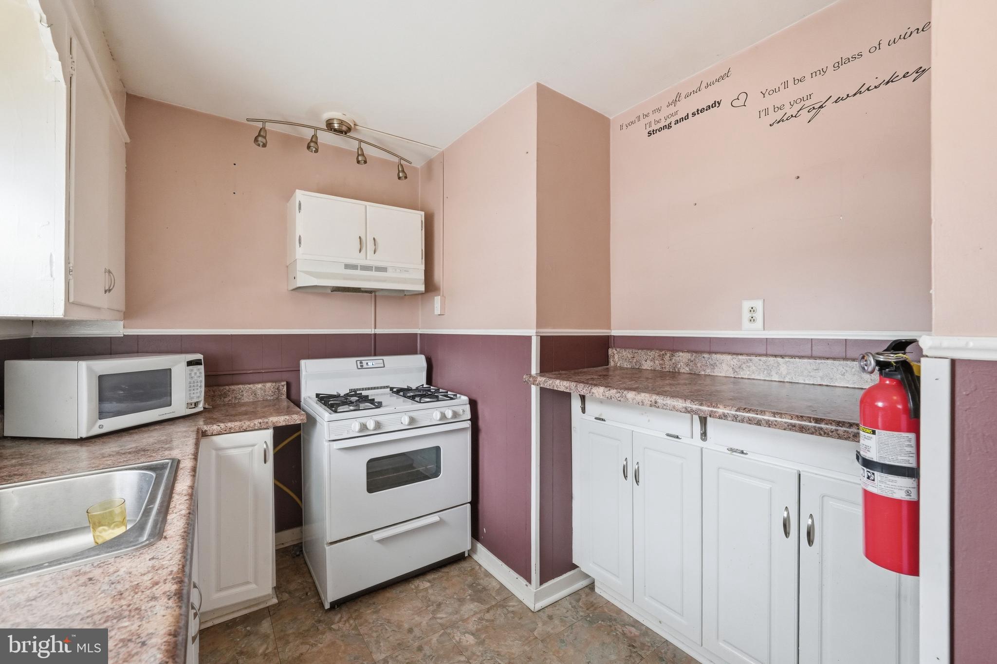 300 Delaware Avenue Riverside, NJ 08075 - Photo 72 of 86 a kitchen with a stove and a refrigerator