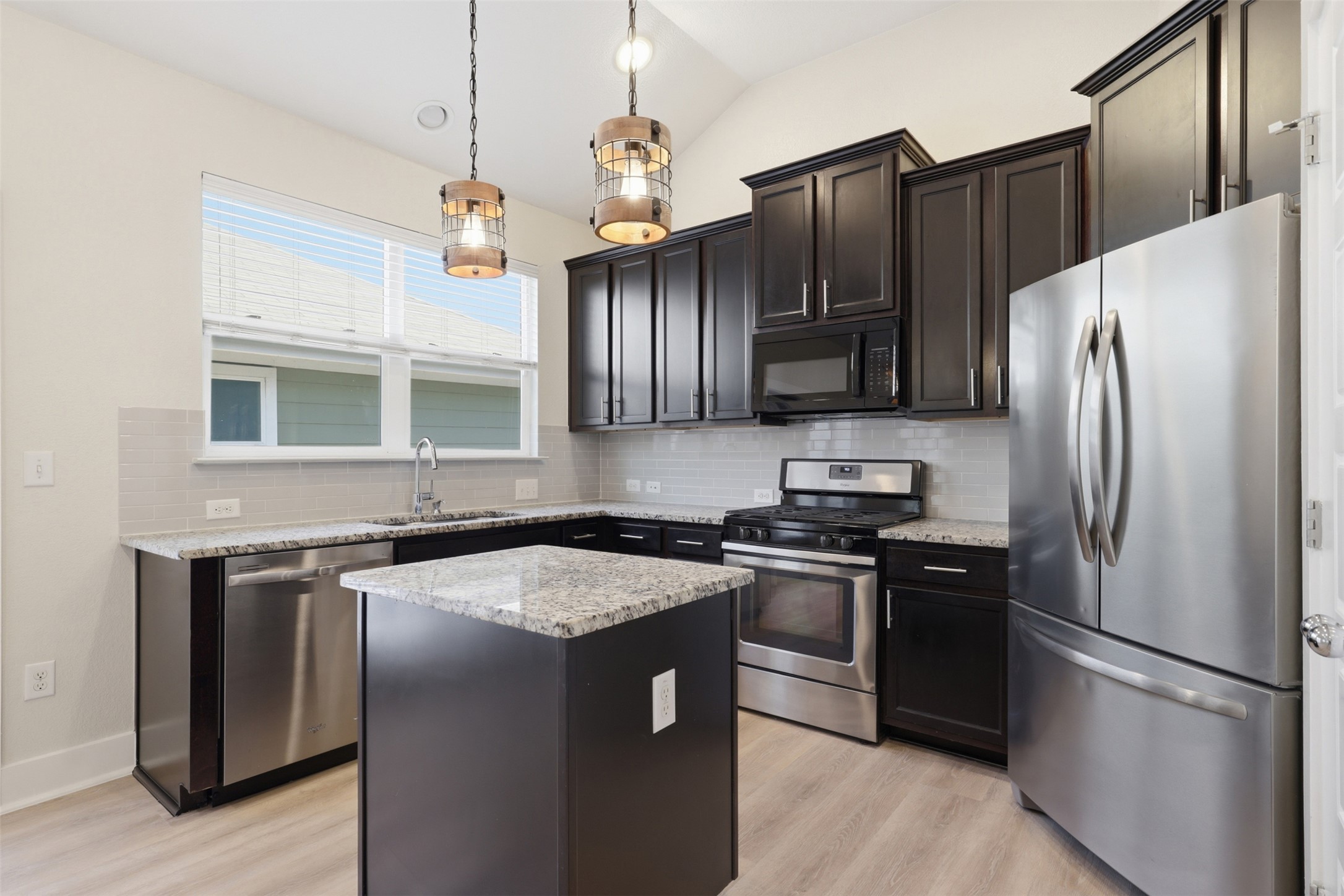7208 Lysander Court Austin, TX 78741 - Photo 7 of 15 a kitchen with stainless steel appliances granite countertop a stove a refrigerator and a sink