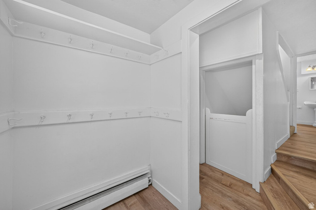 220 East Greenwood Avenue Midvale, UT 84047 - Photo 22 of 46 Entryway featuring wood-finish flooring, white walls, and built-in coat hooks with an overhead shelf