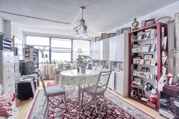 a dining room with lots of furniture and a book shelf
