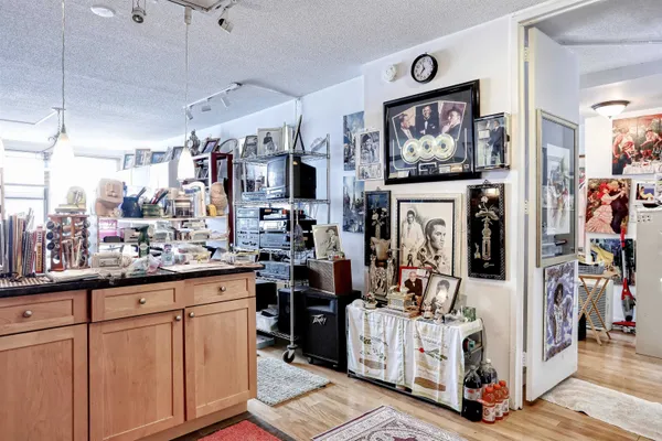 a view of a kitchen with fridge and workspace