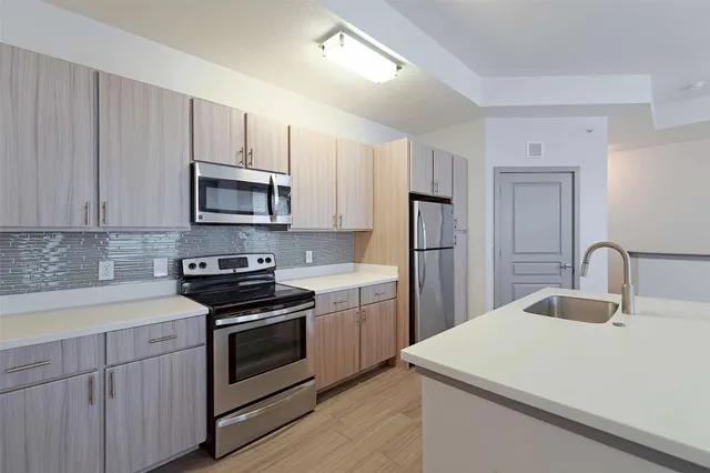 a kitchen with a sink stove and refrigerator