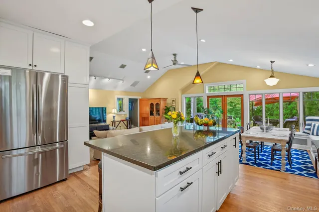 a kitchen with stainless steel appliances granite countertop a refrigerator a sink and a stove