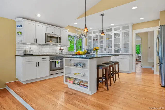 a kitchen with stainless steel appliances granite countertop a stove and cabinets