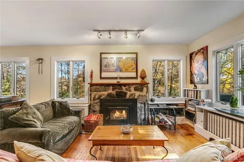 a living room with furniture large window and a fireplace
