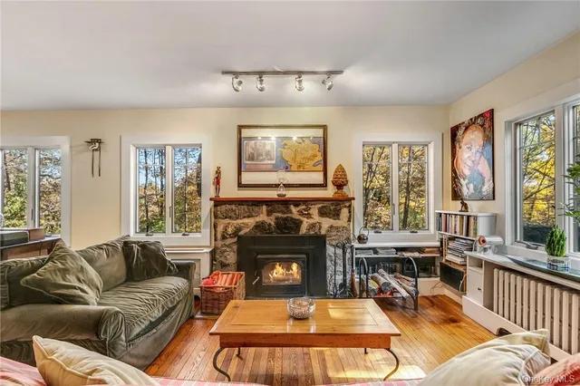 a living room with furniture large window and a fireplace