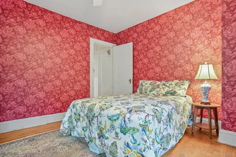 a bedroom with a bed and a painting on the wall