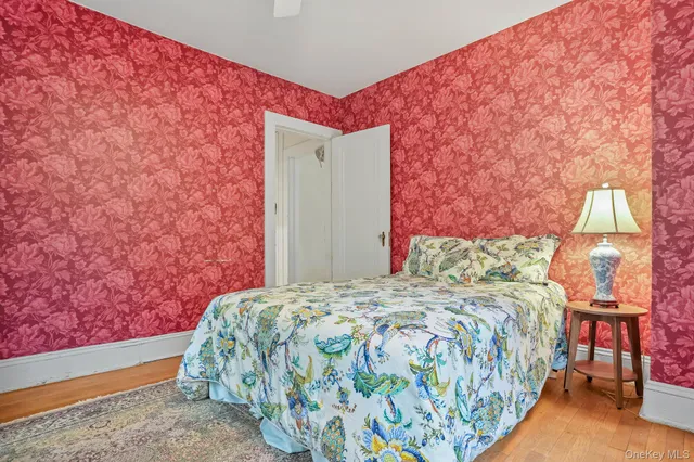 a bedroom with a bed and a painting on the wall