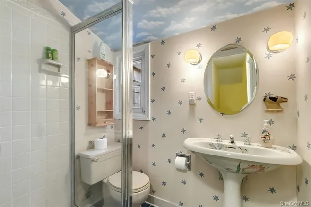 a bathroom with a sink toilet and shower